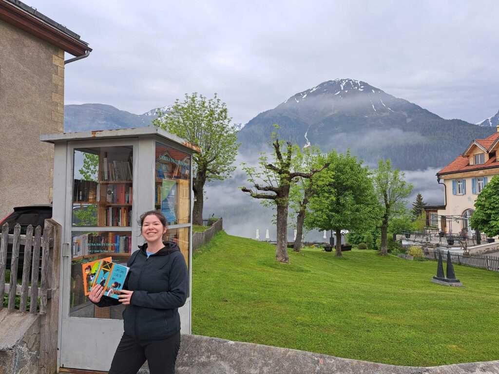 Megan enjoying one of her favorite hobbies: visiting the little free libraries all around the Swiss Alps!